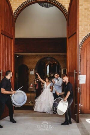 Gledswood Wedding - the bride and groom exit the church to Turkish drummers