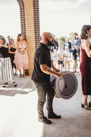 Gledswood Wedding - the bride and groom exit the church to Turkish drummers
