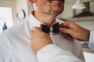Gledswood Wedding - Groom prep groomsman attached the grooms tie