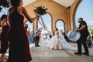 Gledswood Wedding - the bride and groom exit the church to Turkish drummers