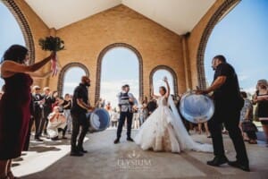 Gledswood Wedding - the bride and groom exit the church to Turkish drummers