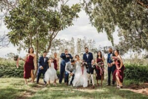 Gledswood Wedding - newlyweds stand with their bridal party in the gardens at the venue