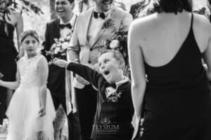 Gledswood Wedding - newlyweds stand with their bridal party in the gardens at the venue