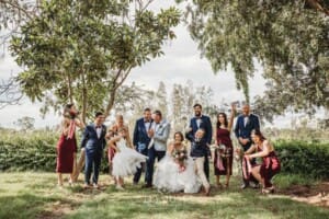 Gledswood Wedding - newlyweds stand with their bridal party in the gardens at the venue