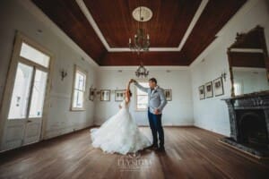 Gledswood Wedding - a bride and groom dance in the music room at their reception venue