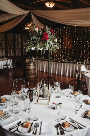 Gledswood Wedding - a floral centerpiece sits on a table in the reception venue