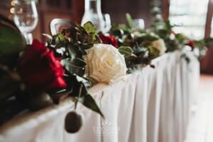 Gledswood Wedding - a floral centerpiece sits on a table in the reception venue
