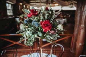 Gledswood Wedding - a floral centerpiece sits on a table in the reception venue