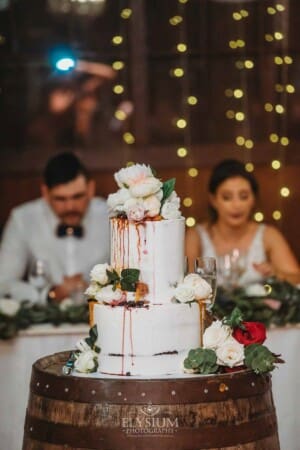 Gledswood Wedding - wedding cake sits in front of the bridal table