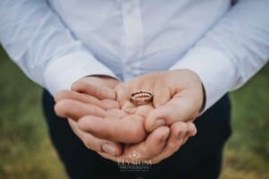 Gledswood Wedding - a groom holds the wedding rings in his hands