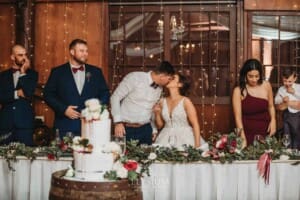 Gledswood Wedding - a bride and groom share a kiss at the bridal table