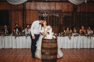 Gledswood Wedding - a bride and groom cut the wedding cake at the reception