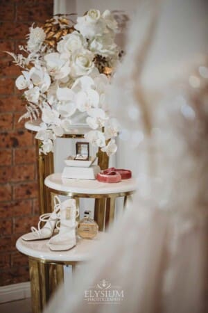 Gledswood Wedding - bridal jewelry and shoes displayed on a stand