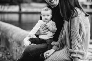 Baby photography - a little girl sits in her parents laps