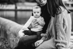 Baby photography - a little girl sits in her parents laps