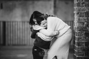 Family Photographer: a mother cuddles her son at Paddington Reservoir Gardens