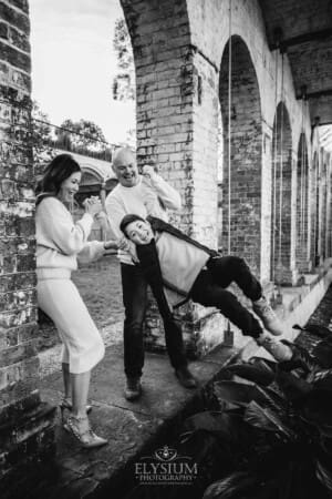 Family Photography: parents swinging their son between them at Paddington Reservoir Gardens