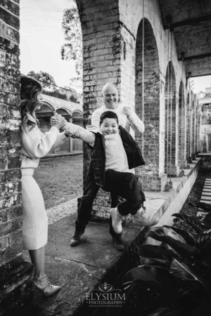 Family Photography: parents swinging their son between them at Paddington Reservoir Gardens
