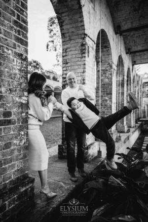 Family Photography: parents swinging their son between them at Paddington Reservoir Gardens