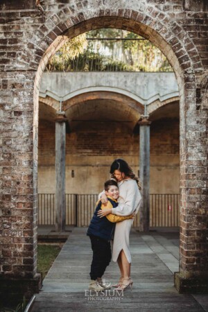 Family Photographer: a mother cuddles her son at Paddington Reservoir Gardens