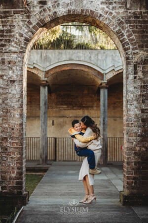 Family Photographer: a mother cuddles her son at Paddington Reservoir Gardens