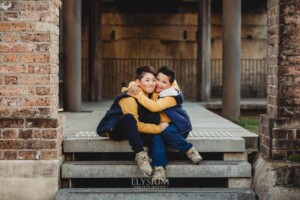 Family Photographer: brothers sit together on steps at Paddington Reservoir Gardens