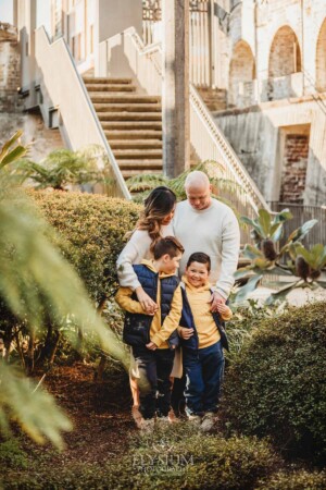 Sydney Family Photographer: parents cuddle their sons in Paddington Reservoir Gardens