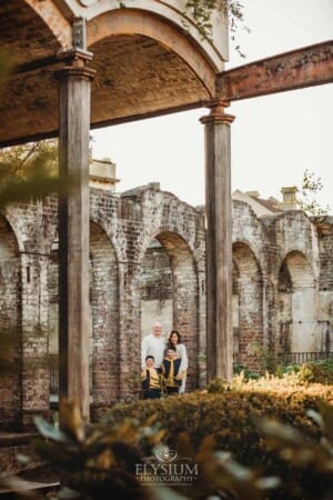 Sydney Family Photographer: parents cuddle their sons in Paddington Reservoir Gardens