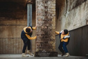 Sydney Family Photographer: brother chase each other round a rustic brick wall