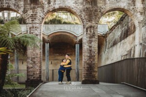Sydney Family Photographer: brothers stand hugging under a rustic brick arch