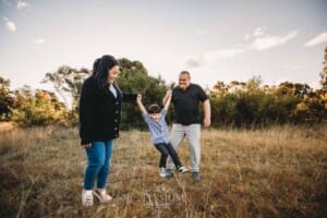 Family Photography: parents walk swinging their little boy between them