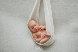 Newborn Photography: a baby boy wrapped in a white blanket