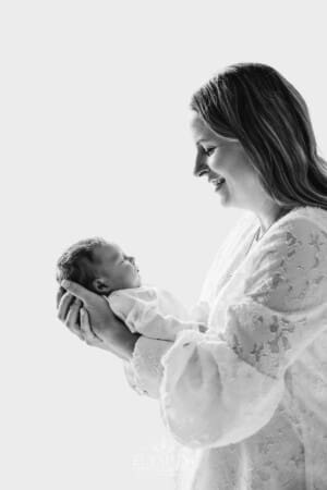 A mother holds her baby girl in her arms