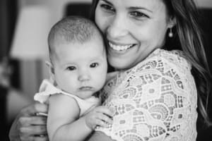 Newborn Photography: a mother hugs her baby girl