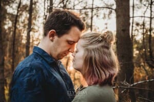 Engagement Photographer: a couple standing with foreheads together at sunset
