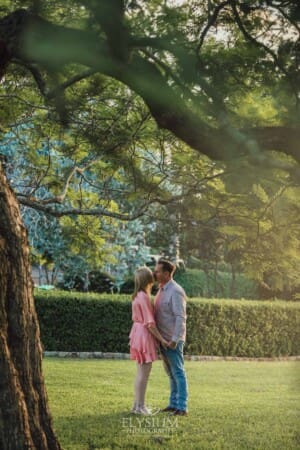 Engagement Photography: a man kisses his girlfriend on the forehead at sunset