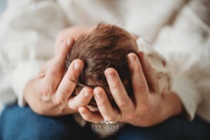 A mum holds her baby girl's tiny head