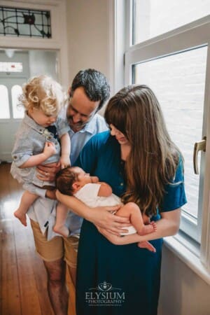 Newborn Photography: parents hold their baby boys in their arms