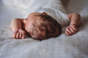 Newborn Photography: a baby boy's soft hair laying on a white blanket