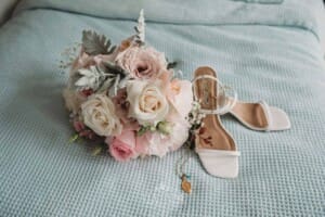 Sydney Wedding - a brides shoes and bouquet sitting on a blue blanket