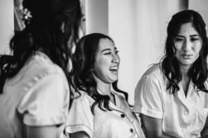 Sydney Wedding - a bride laughing with her bridesmaids as they get ready