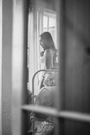 Sydney Wedding - a bride reflected in a glass door as she gets ready