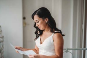 Sydney Wedding - a bride sits down to read a letter from her groom