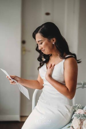 Sydney Wedding - a bride sits down to read a letter from her groom