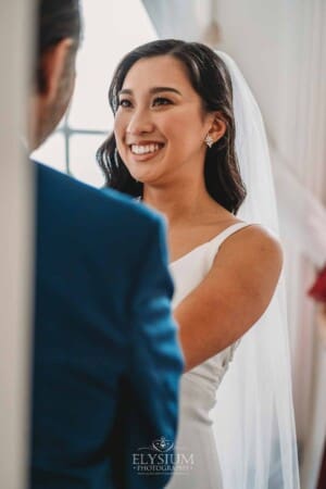 Sydney Wedding - a bride in a wedding gown smiles up at her father