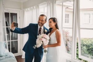 Sydney Wedding - a bride and her father take a selfie in a bright room