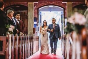 Sydney Wedding - a bride and her father walk down the church aisle