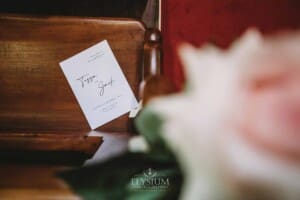Sydney Wedding - a wedding program sits on a bench at the ceremony