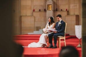 Sydney Wedding - a bride and groom sit in the church during the ceremony