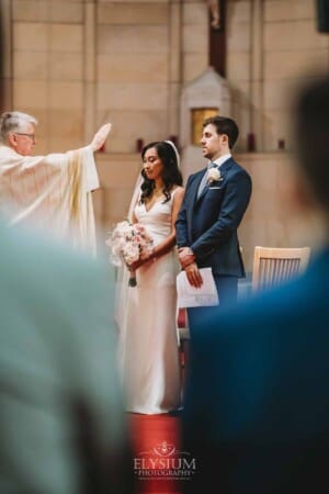 Sydney Wedding - bride and groom receive a blessing from the priest